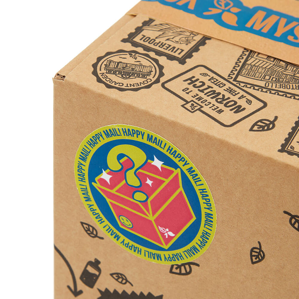 close up of happy mail sticker with mystery tea box graphics on the mystery tea box
