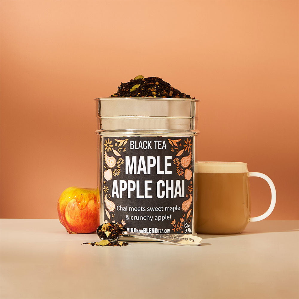 hot maple apple chai latte & apple covered in maple syrup & perfect tea spoon filled with loose leaf tea & maple apple chai custom tea tin