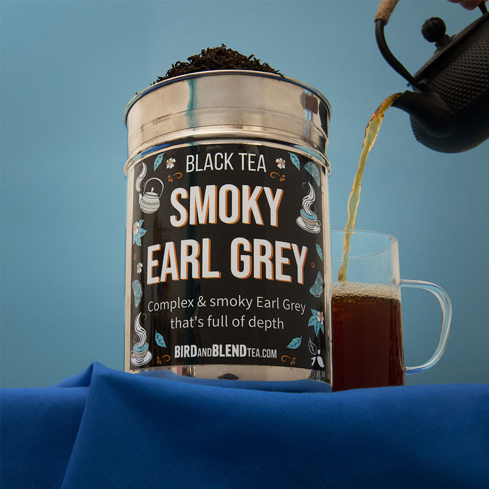 smoky earl grey tea tin with hot cup of tea