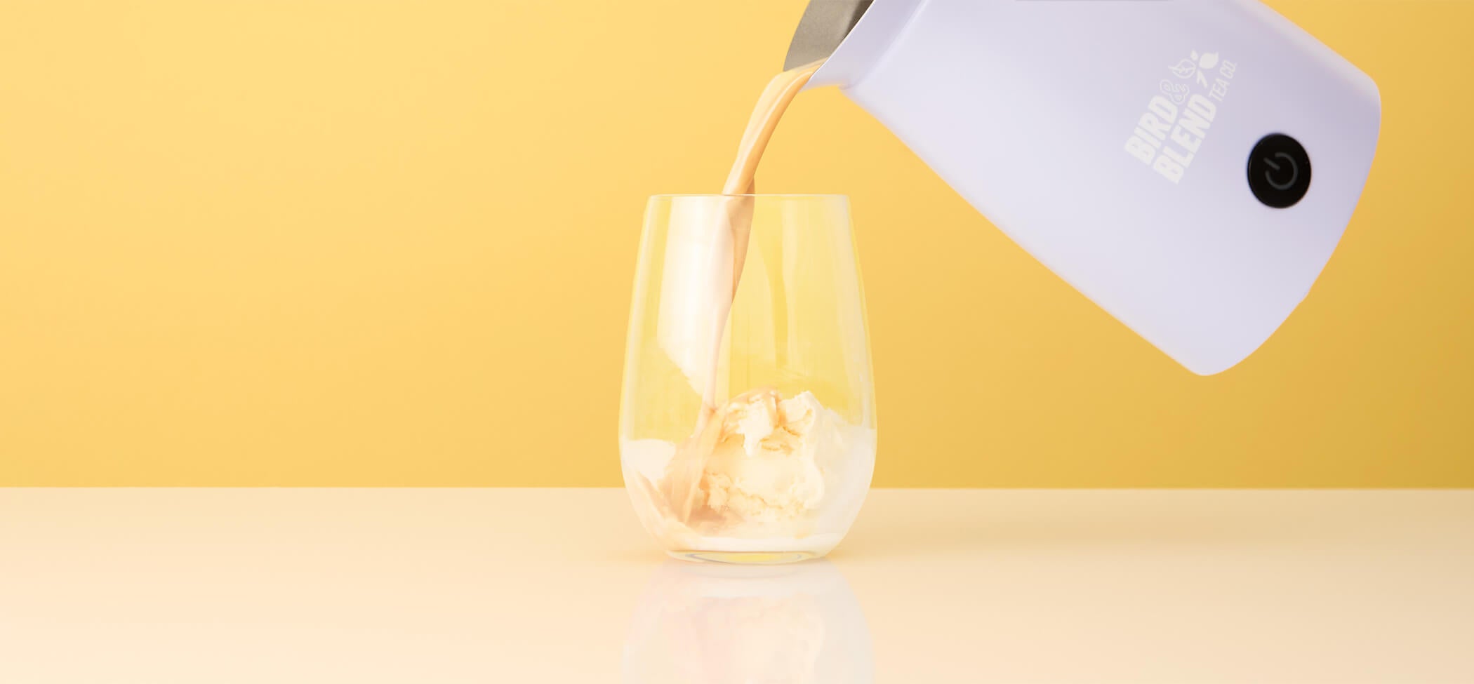 Vanilla Rooibos Tea Powder pouring onto vanilla ice cream from soft lilac matcha latte magic whisk