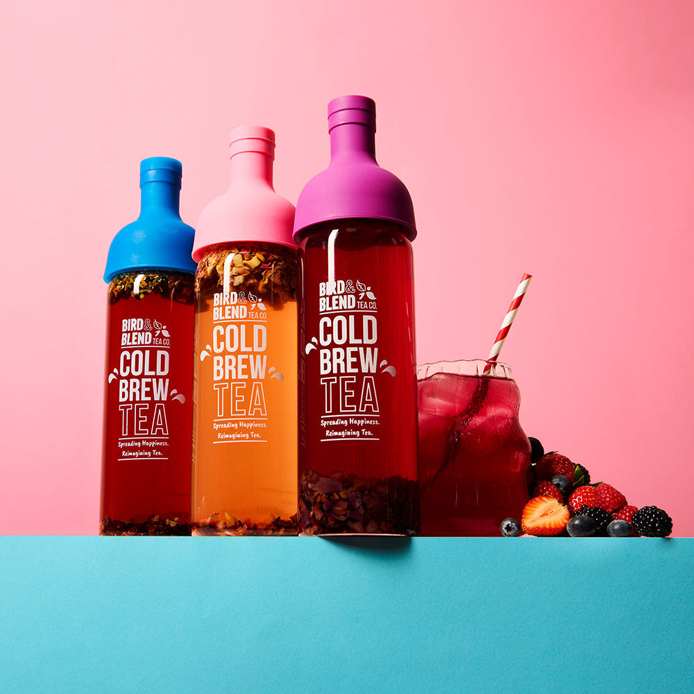 peachy pink plum purple & sapphire blue cold brew tea bottle filled with tea & iced tea