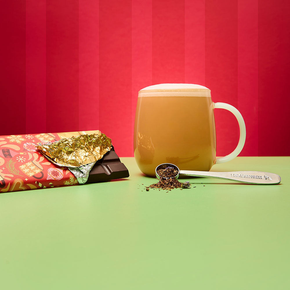 gingerbread chai chocolate bar and hot tea latte and spoon filled with loose leaf tea