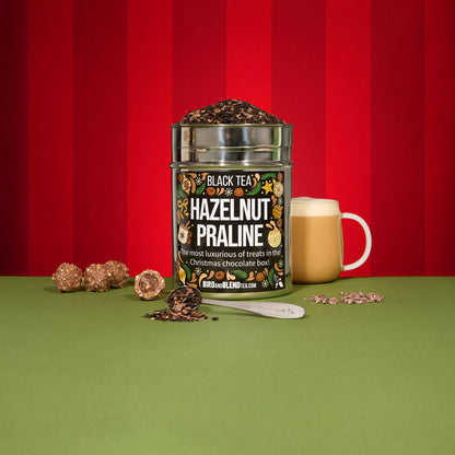 Hazelnut praline tea wall tin and hot tea latte and spoon filled with loose leaf tea and hot tea latte