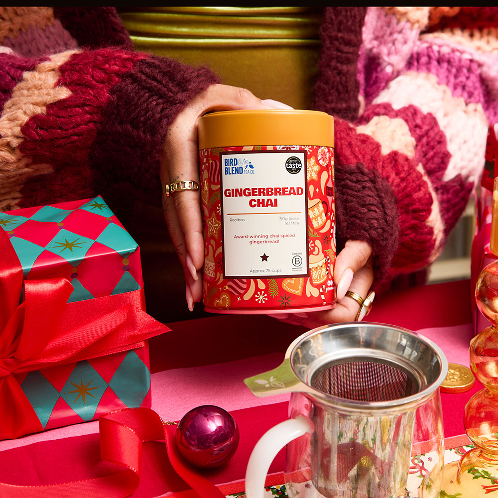 person holding gingerbread chai tea gift tin