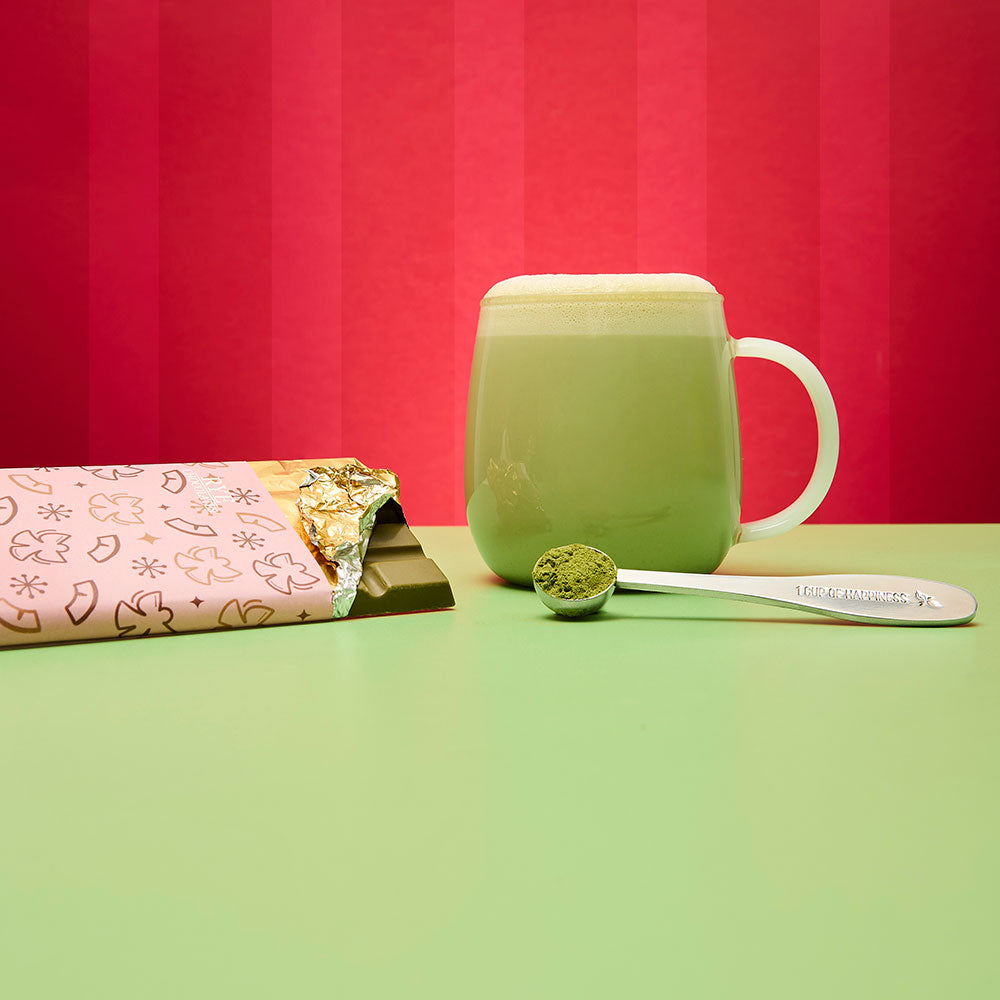 snow angel matcha chocolate bar and hot tea and spoon filled with matcha