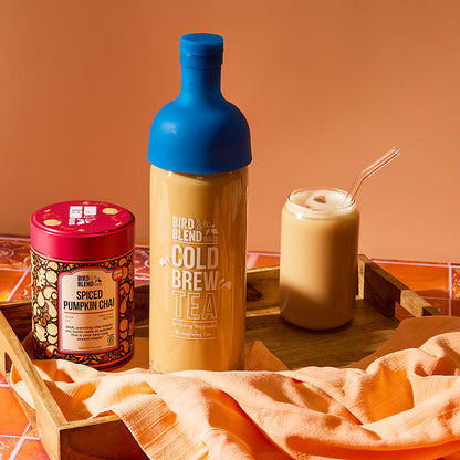 spiced pumpkin chai 150g tin &amp; sapphire blue cold brew tea bottle filled with chai &amp; iced chai latte